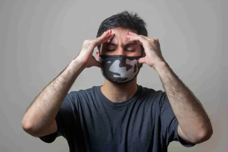 A person covered his head with a headache，said the House Smells Like Gasoline