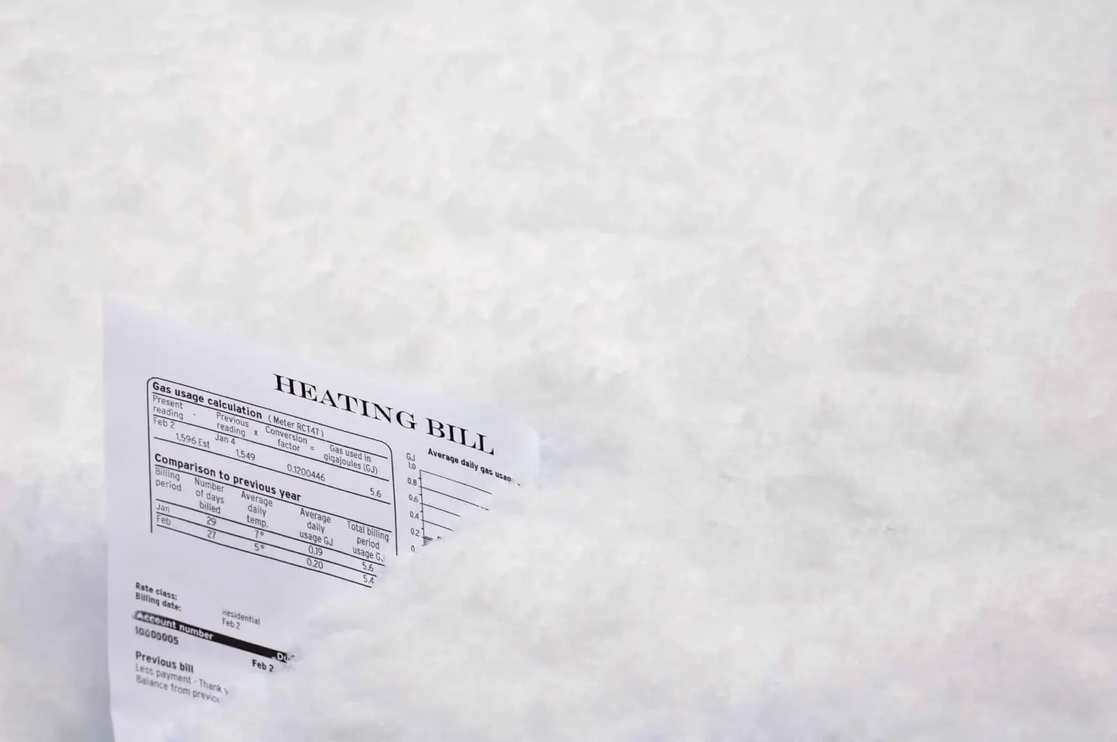 Why Winter Electric Bills Are So High—and What You Can Do About It 1 Heating bill stuck in the snow symbolizing high winter electricity costs