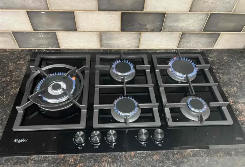 A gas stove with the flame lit e1767863774204 -
