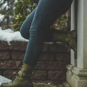 A woman is standing outside the house -