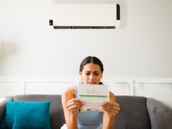 Frustrated homeowner looking at statement and thinking “my electric bill doubled in one month