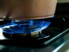 home natural gas detector：Gas stove burner on with pot, potential kitchen gas leak risk