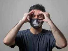 A person covered his head with a headache，said the House Smells Like Gasoline