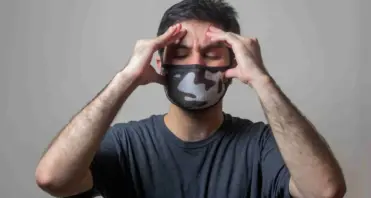 A person covered his head with a headache，said the House Smells Like Gasoline